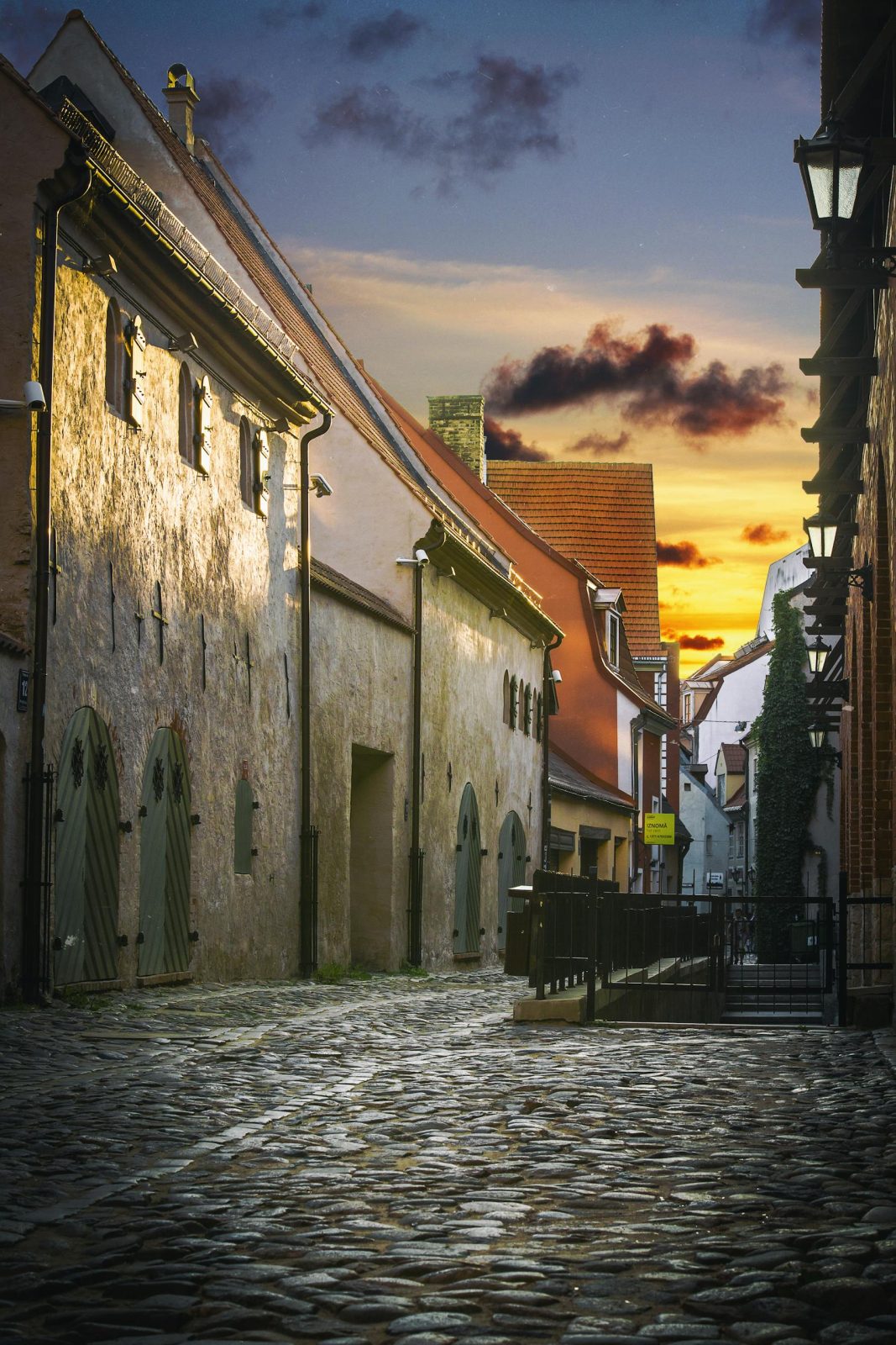 Charming cobblestone street in Riga, Latvia, captured at sunset, highlighting historic architecture and serene atmosphere.