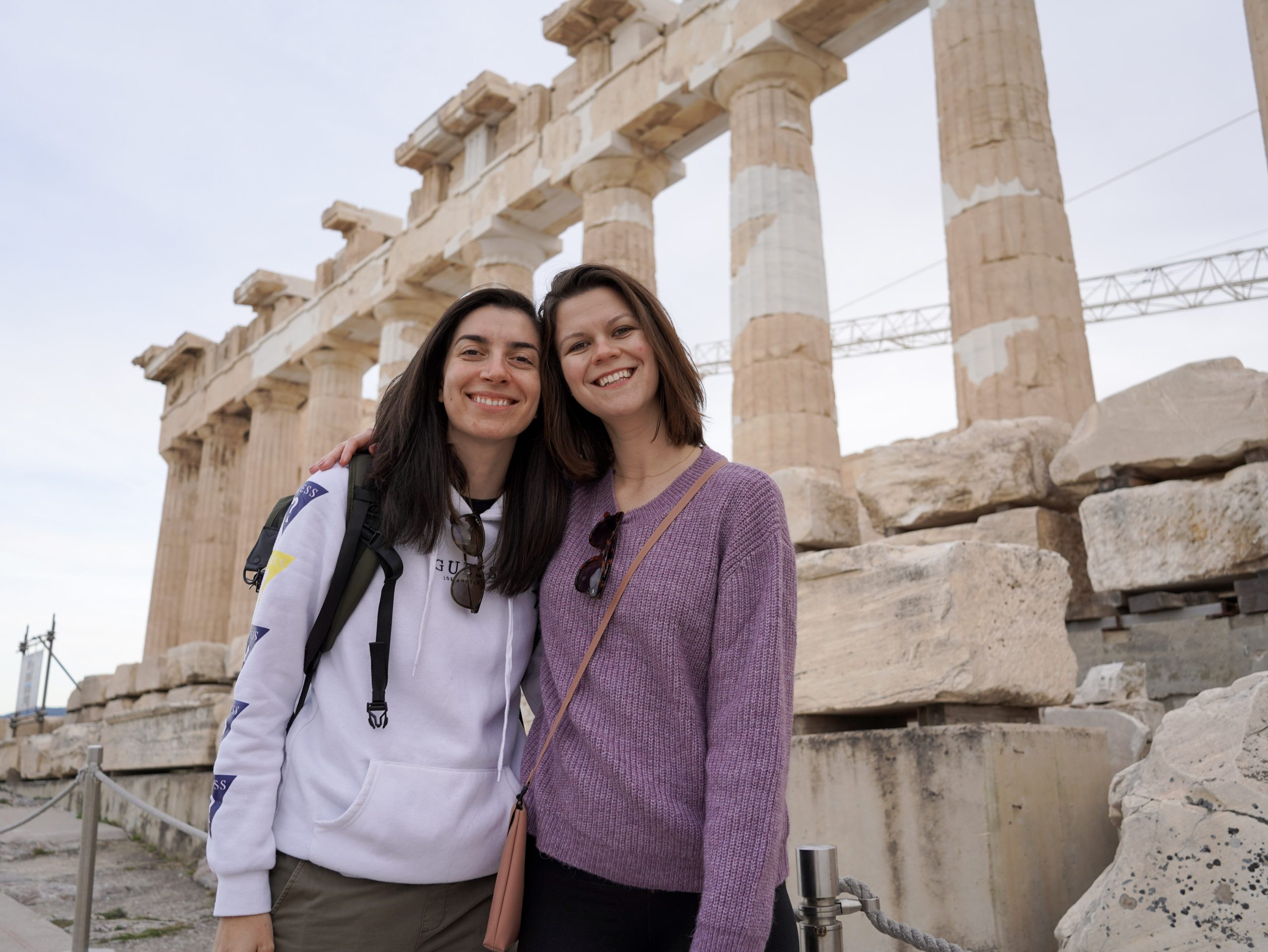 olivia and maria, travel content creators and bloggers that live in Athens in front of the Acropolis