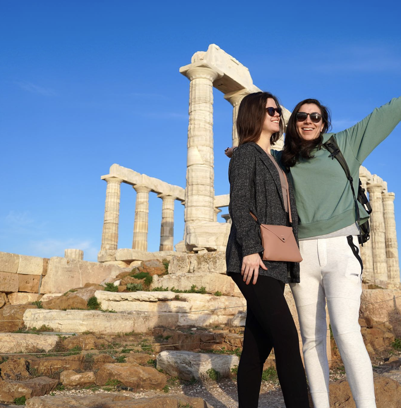 two girls in front of the temple of poseidon in cape sounion in 2025
