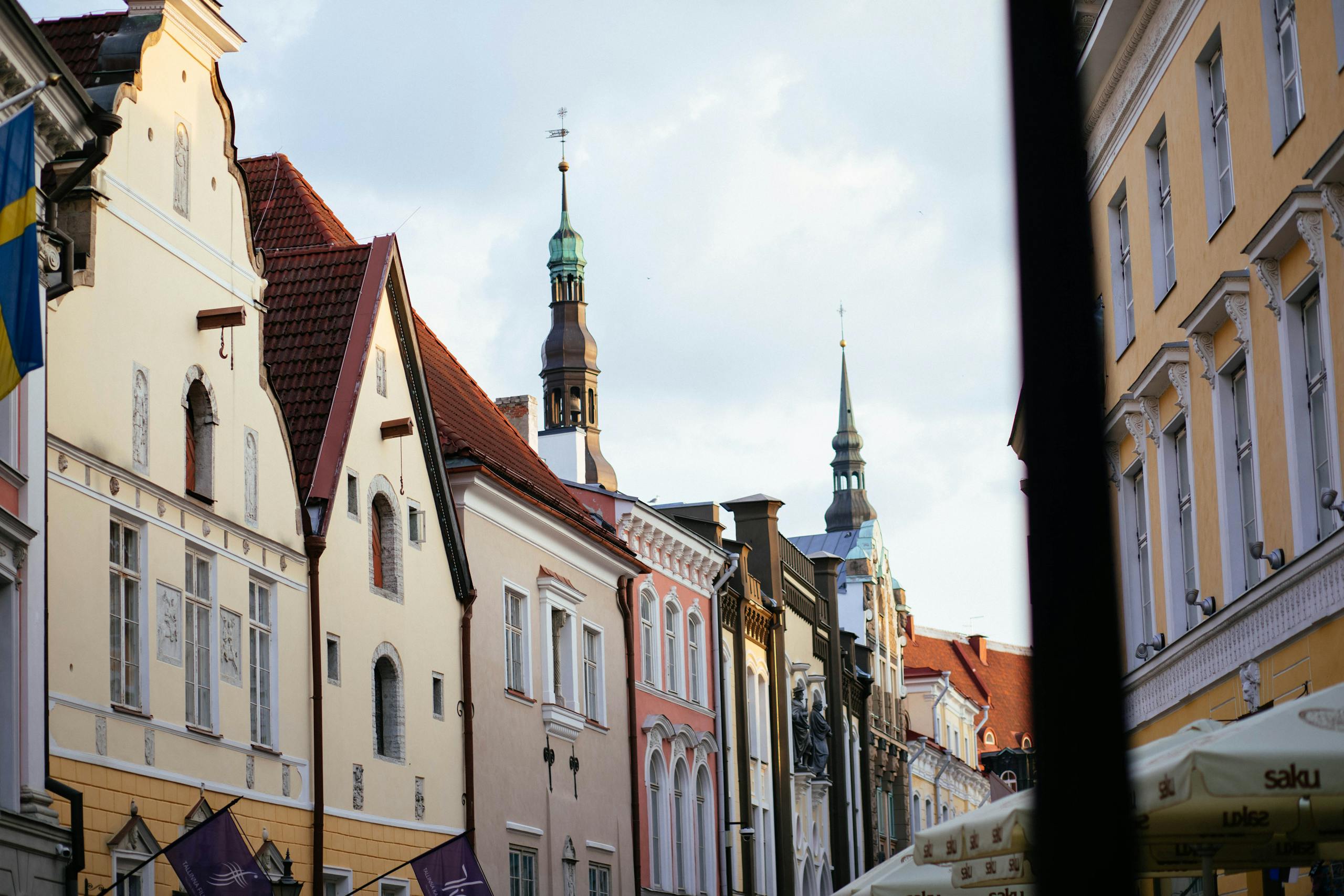 Charming street scene with historic European architecture, featuring classic facades and church spires.