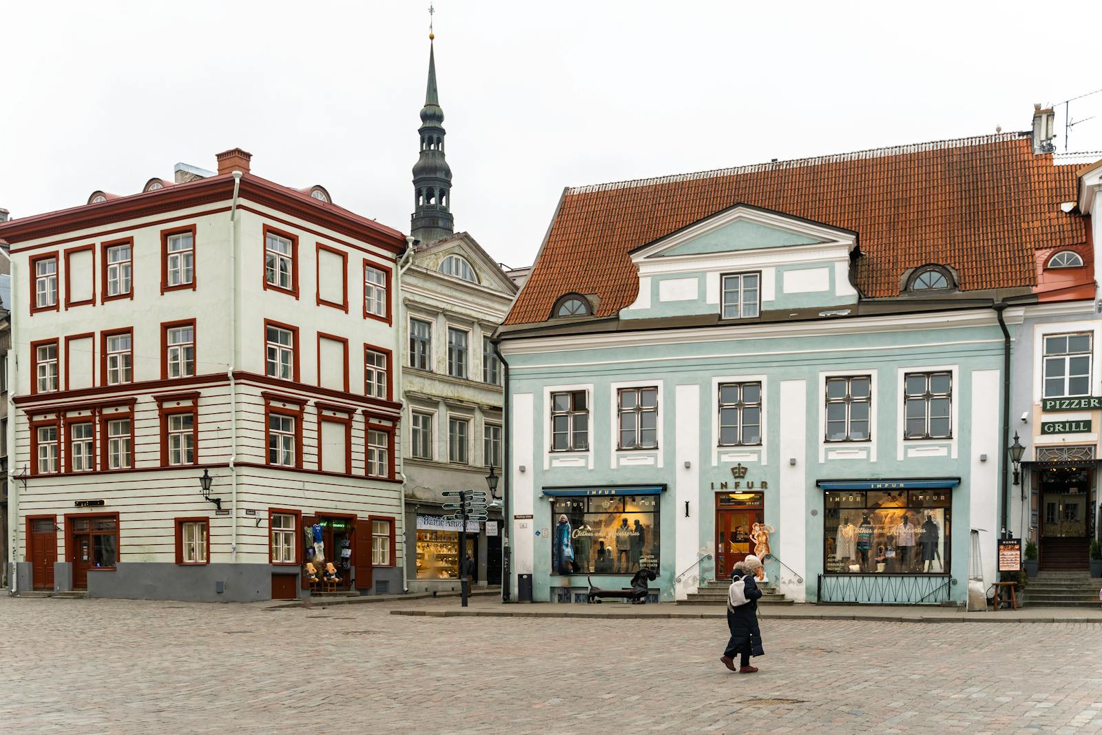 Discover the medieval charm of Tallinn's historic old town square with colorful buildings and cobblestone streets.