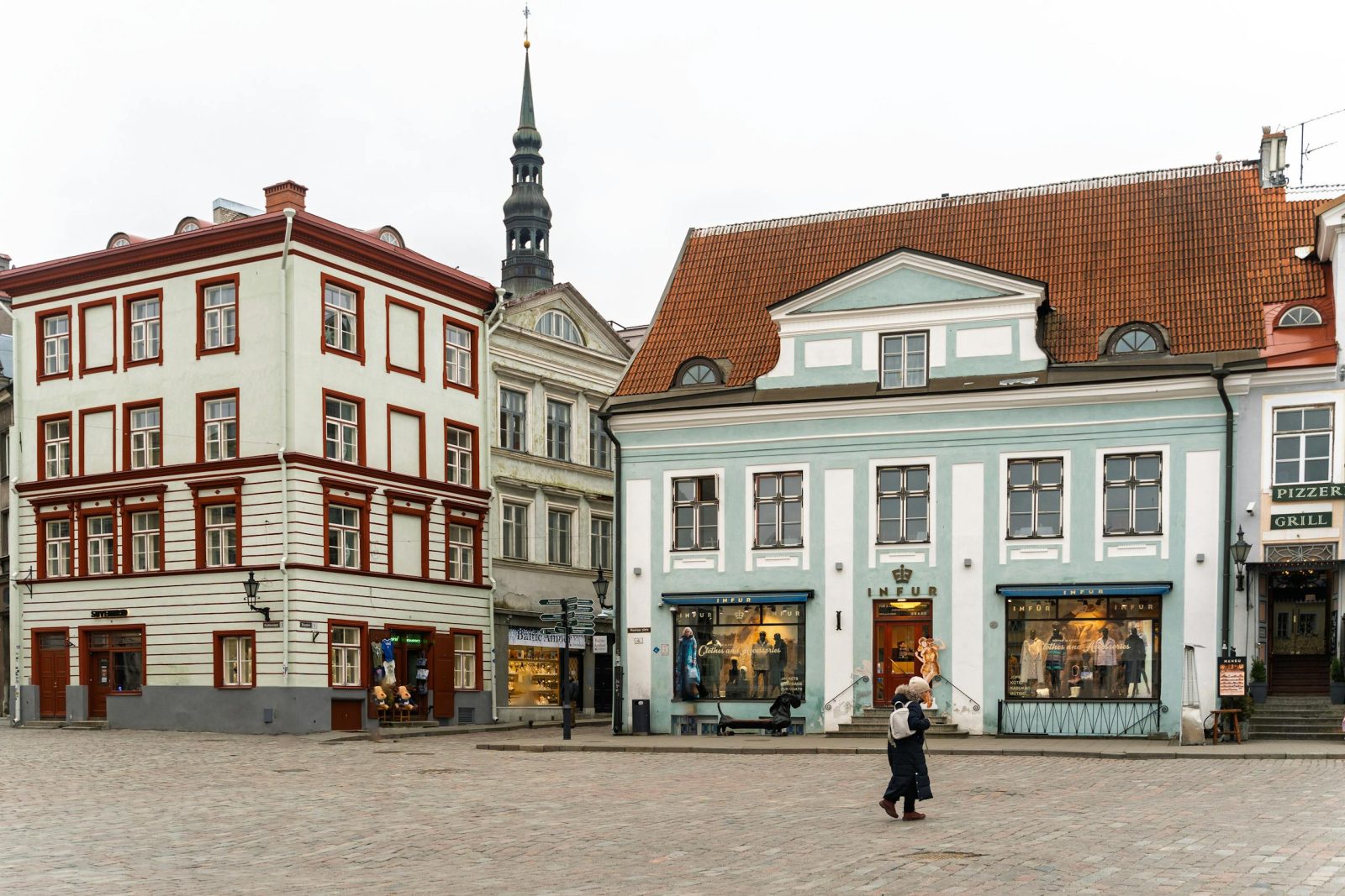 Discover the medieval charm of Tallinn's historic old town square with colorful buildings and cobblestone streets.