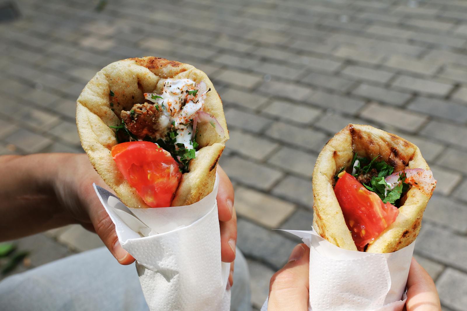Two fresh gyros with tomato and herbs, perfect Greek street food for a sunny day 2025
