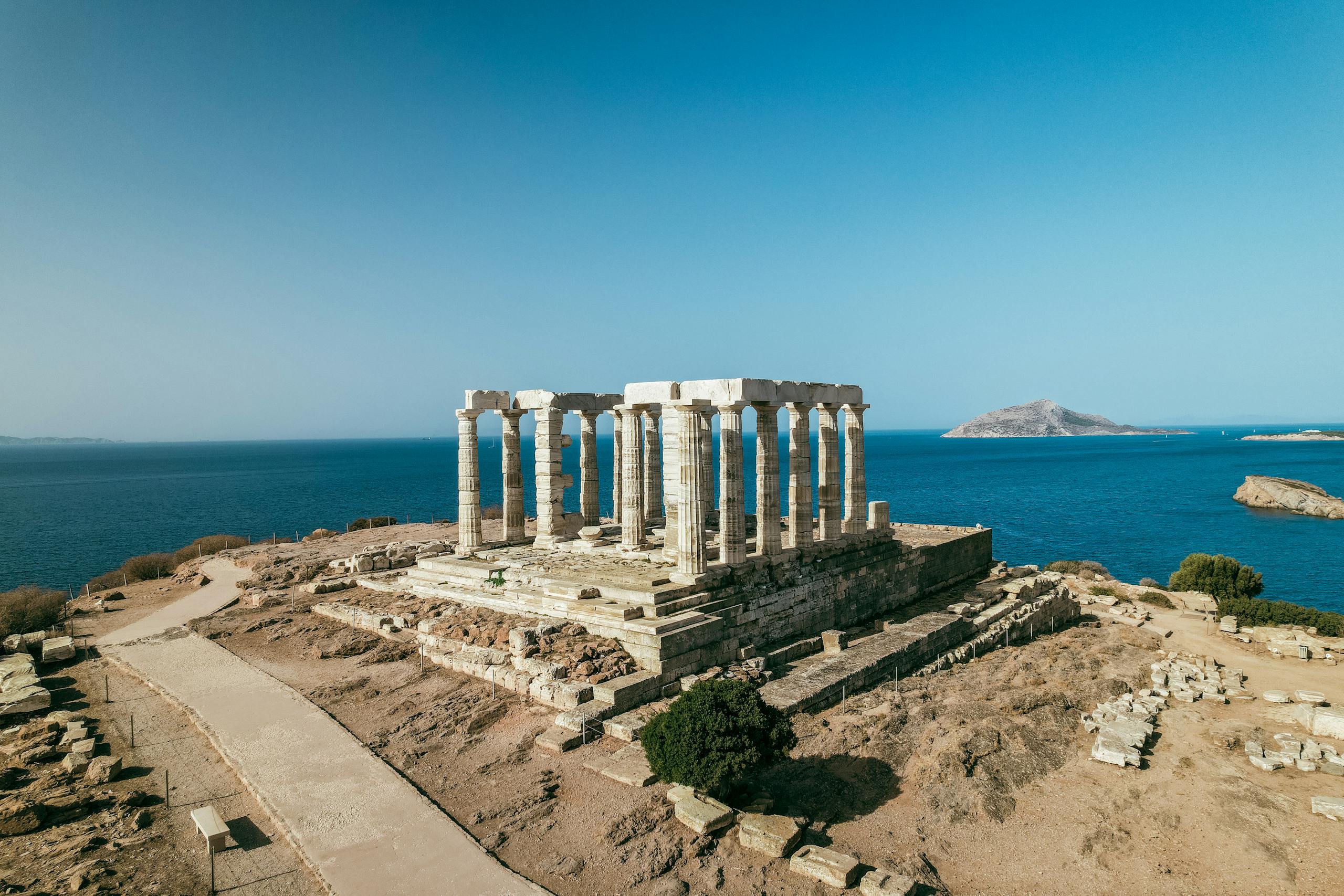 Aerial view of the ancient Temple of Poseidon overlooking the Aegean Sea in Greece.