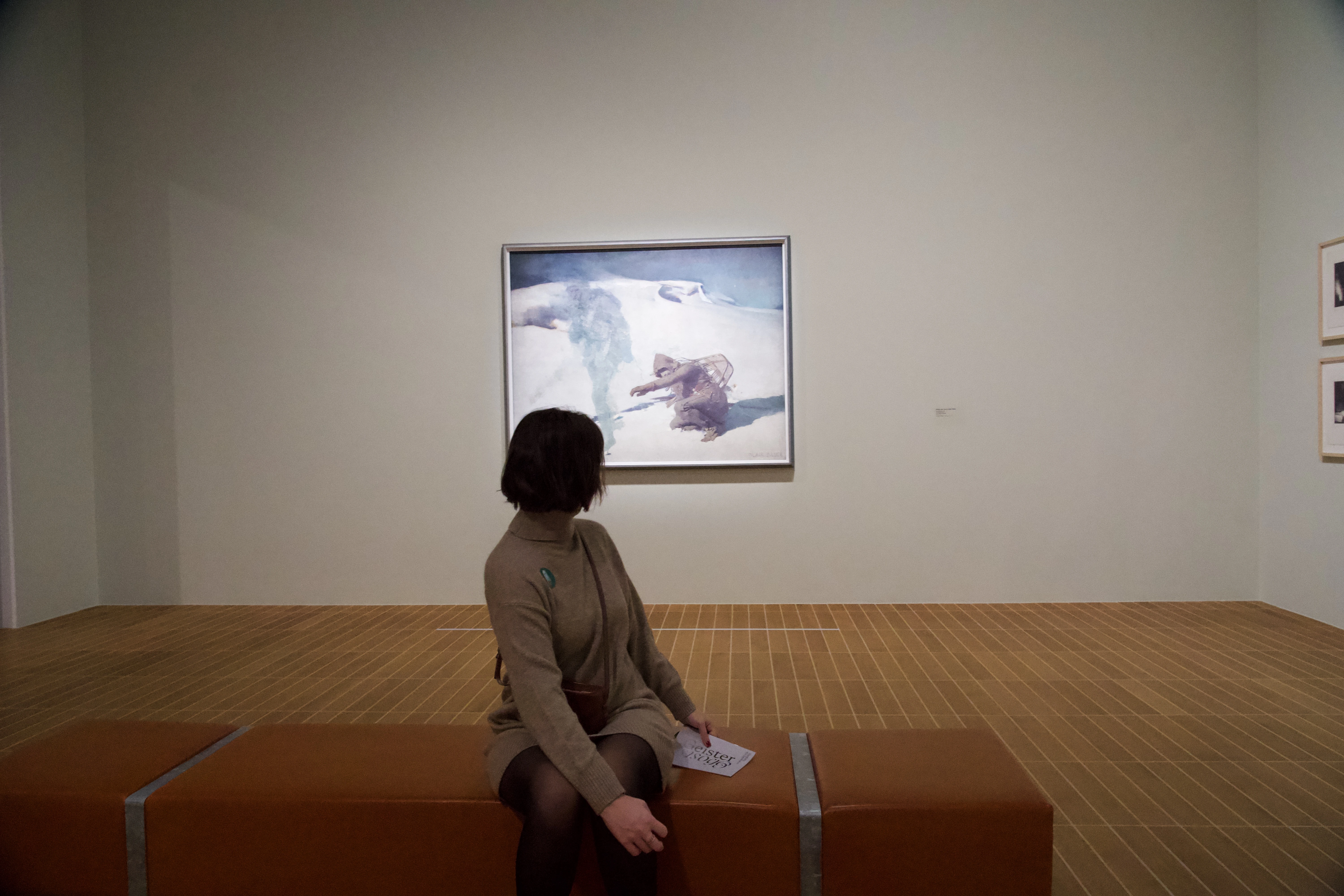 A woman in front of a piece of art at the ghost exhbit at the Kunst Museum