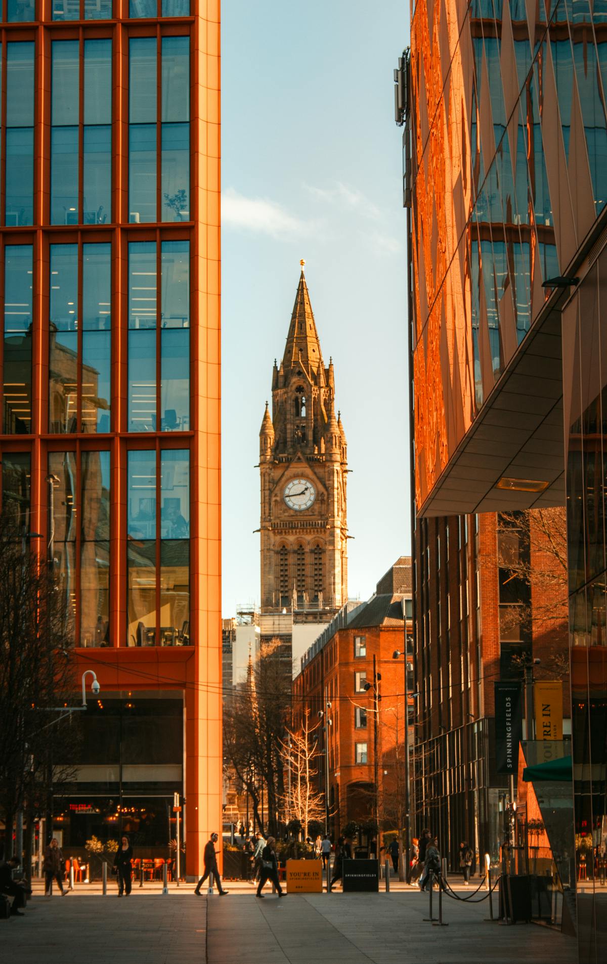 View of Manchester's modern buildings with iconic clock tower in the background.